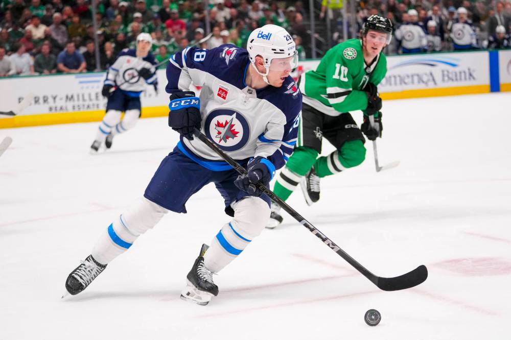 Julio Cortez / The Associated Press
Winnipeg Jets’ Jaret Anderson-Dolan skates with the puck in front of Dallas Stars centre Oskar Back during the first period.