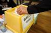 A voter places their ballot in the ballot box at the polling station in the East End Community Centre in Brandon during the municipal election on Wednesday. (Tim Smith/The Brandon Sun)