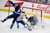 Edmonton Oilers’ Max Jones (46) collides with Winnipeg Jets’ Colin Miller (6) in front of goaltender Eric Comrie (1) during third period NHL action in Winnipeg, Sunday April 13 2025. THE CANADIAN PRESS/Fred Greenslade