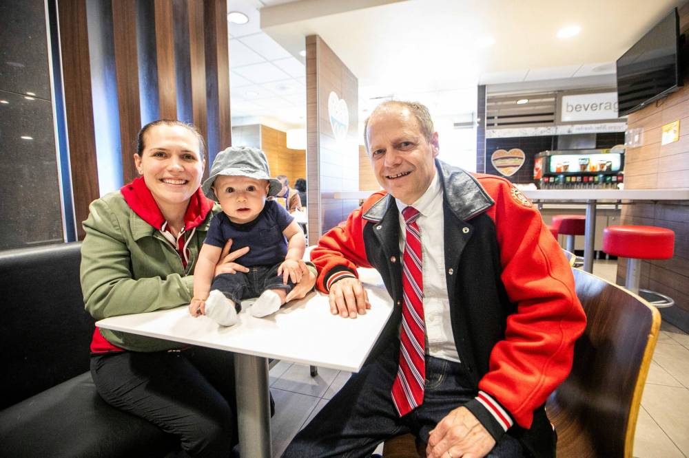MIKAELA MACKENZIE / FREE PRESS
Winnipeg North incumbent MP Kevin Lamoureux, his daughter, MLA Cindy Lamoureux, and her son, 5-month-old Hudson Burns, at the Keewatin Street McDonald’s that becomes a town hall for the two politicians every Saturday.