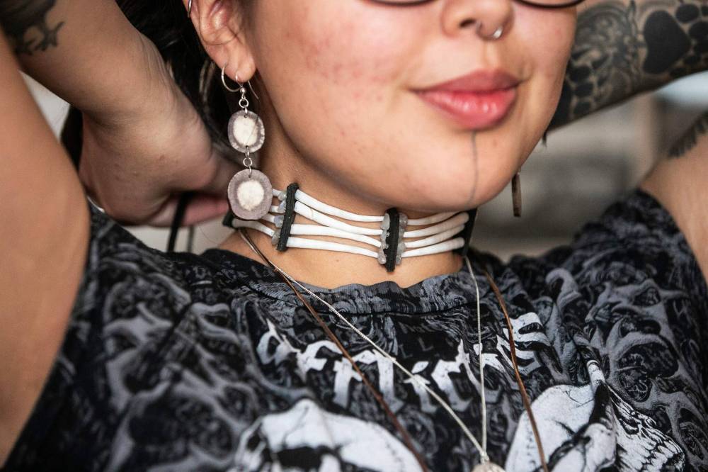 MIKAELA MACKENZIE / FREE PRESS
Ryleigh Todd-Moore puts on one of their dentalium chokers.