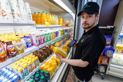 MIKE DEAL / FREE PRESS Brayden Halayko, store supervisor of Downtown Family Foods, 120 Donald St. Downtown Family Foods has noticed an increased cost on its U.S. imports, like orange juice and canned soups. As such, it’s been bringing on more Canadian products. Reporter: Dean Pritchard 250416 - Wednesday, April 16, 2025.