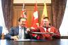 MIKAELA MACKENZIE / FREE PRESS
                                Manitoba premier Wab Kinew (left) and Nunavut premier P.J. Akeeagok sign a joint statement regarding an energy corridor between Manitoba and Nunavut on Wednesday.