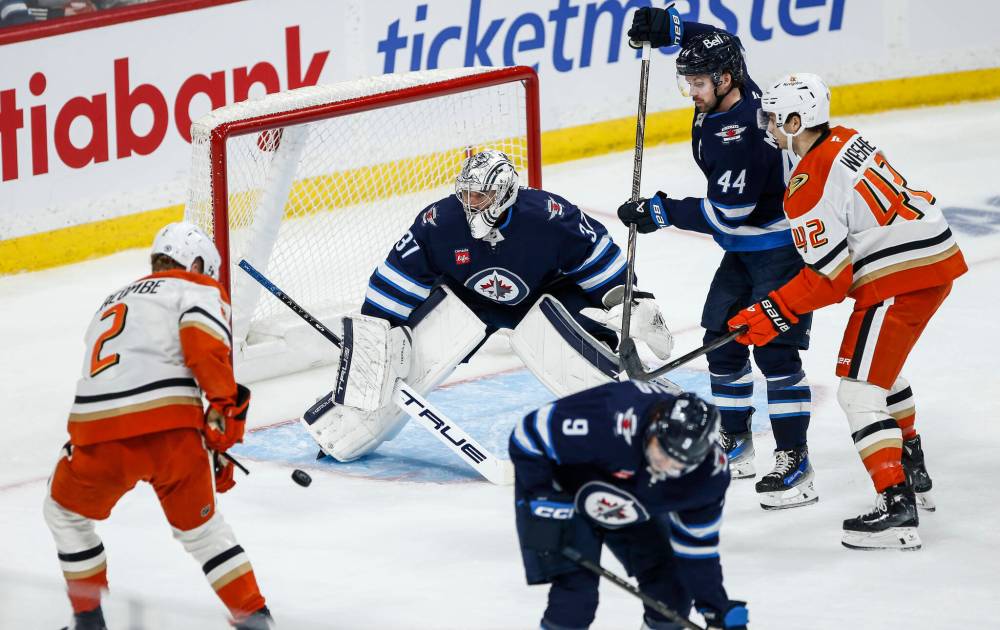 John Woods / THE CANADIAN PRESS
Winnipeg Jets goaltender Connor Hellebuyck saves a shot from Anaheim Ducks’ Jackson LaCombe during the second period.