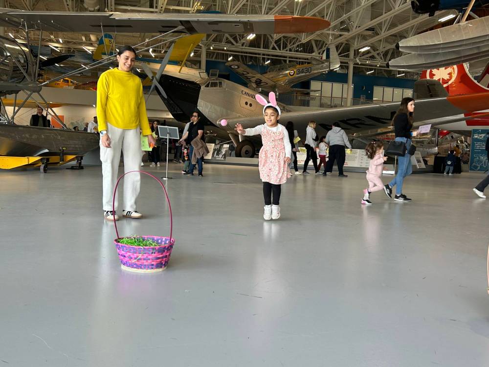 NICOLE BUFFIE / FREE PRESS
                                Ibaadat Tung, 5, tries her luck at the Easter egg toss at the Royal Aviation Museum of Western Canada’s third-annual Easter event.