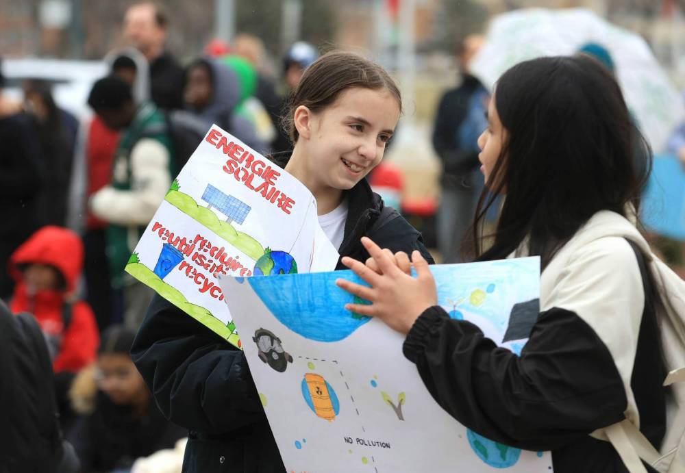 Ruth Bonneville / Free Press
Talia Spence (left) and Cataleya Rapisura display their homemade signs at the Earth Day rally.