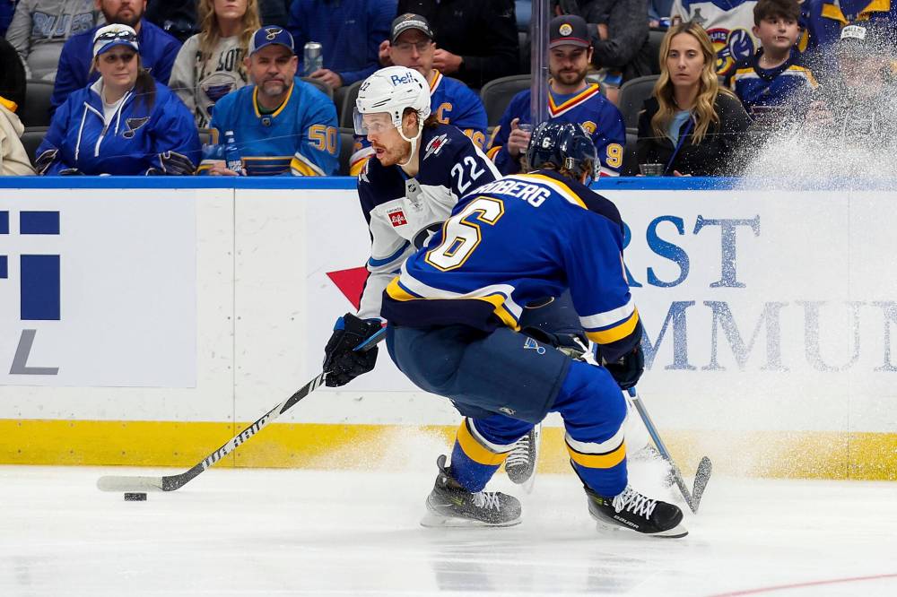 Scott Kane / The Associated Press
Winnipeg Jets’ Mason Appleton controls the puck while under pressure from St. Louis Blues’ Philip Broberg during the first period.