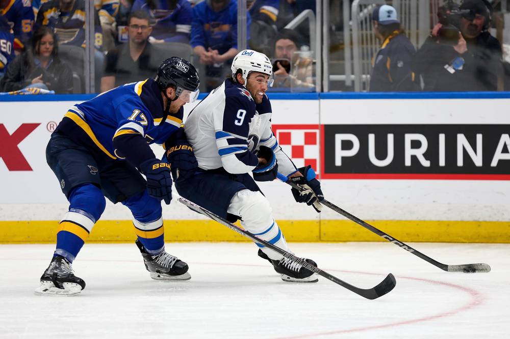 Scott Kane / The Associated Press
Winnipeg Jets’ Alex Iafallo tries to drive wide around St. Louis Blues’ Cam Fowler during the first period.