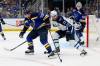 SCOTT KANE / THE ASSOCIATED PRESS
                                St. Louis Blues’ Justin Faulk and Winnipeg Jets’ Adam Lowry vie for control of the puck during the first period in St. Louis Thursday.
