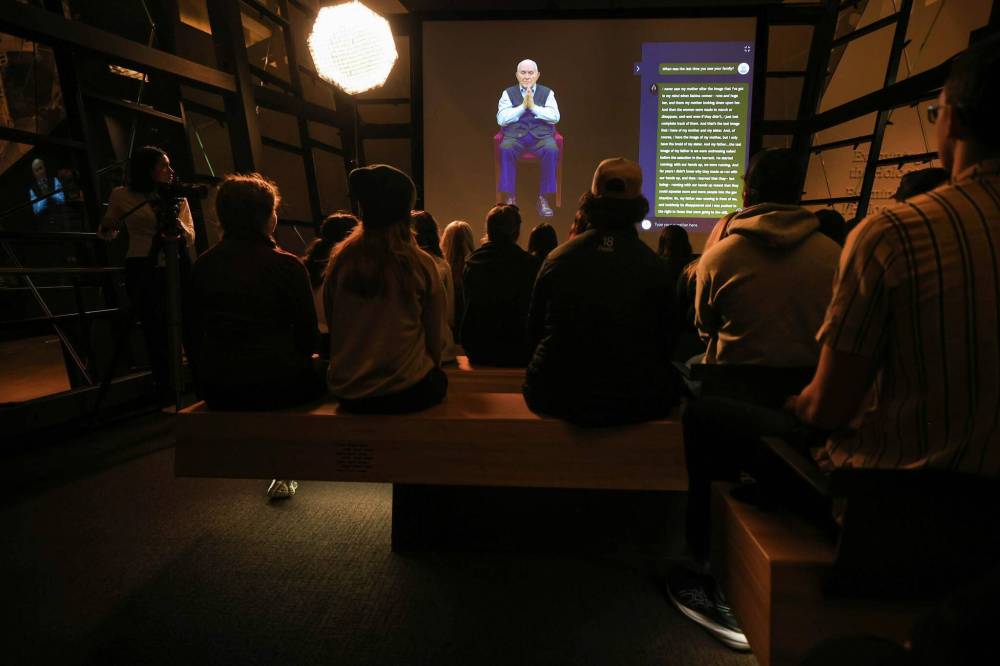 An image of Holocaust survivor Pinchas Gutter interacts with Grade 11 and 12 students from École Héritage through an innovative program called Dimensions in Testimony at the Canadian Museum for Human Rights. (Ruth Bonneville / Free Press)