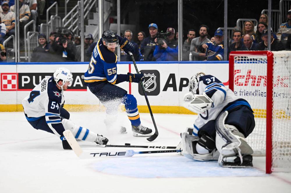 Connor Hamilton / THE ASSOCIATED PRESS
Winnipeg Jets’ Dylan Samberg (left) and Connor Hellebuyck (right) defend the net against the Blues’ Colton Parayko at Enterprise Center Sunday afternoon in St. Louis.