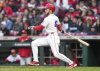 Cincinnati Reds' Gavin Lux watches his RBI single during the third inning of a baseball game against the Seattle Mariners, Tuesday, April 15, 2025, in Cincinnati. All the players are wearing 42 in honor of Jackie Robinson Day. (AP Photo/Jeff Dean)