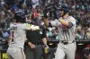 Atlanta Braves' Eli White celebrates with Ozzie Albies (1) after hitting a two run home run against the Arizona Diamondbacks in the seventh inning during a baseball game, Saturday, April 26, 2025, in Phoenix. (AP Photo/Rick Scuteri)