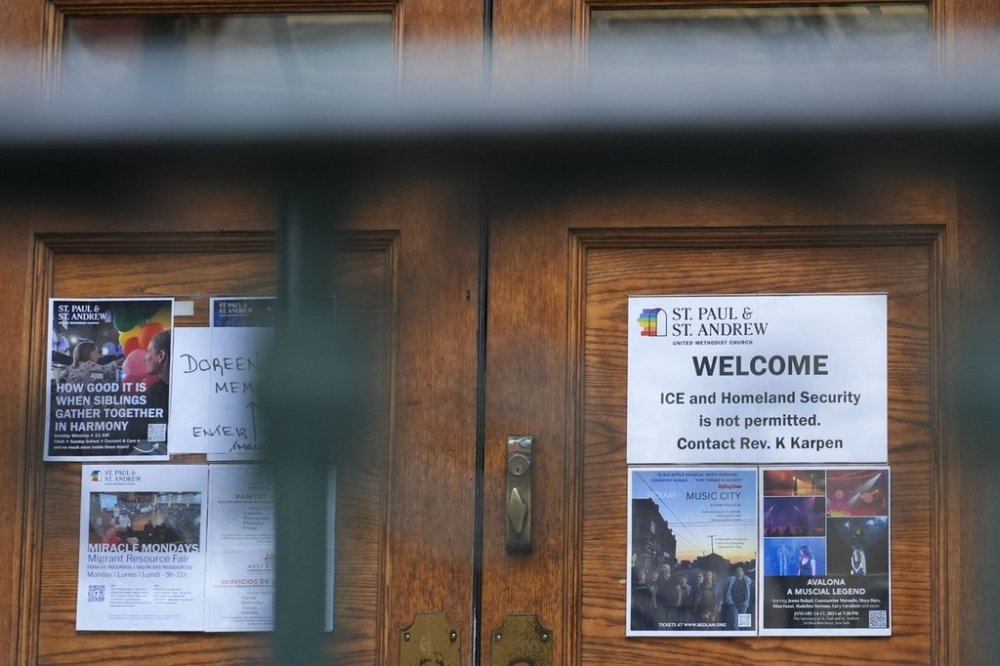 FILE - A sign that prohibits the entrance of ICE or Homeland Security is posted on a door at St. Paul and St. Andrew United Methodist Church in New York, Jan. 21, 2025. (AP Photo/Seth Wenig, File)
