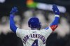 Chicago Cubs' Pete Crow-Armstrong (4) raises his arms after hitting a single during the fifth inning of a baseball game against the Los Angeles Dodgers, Wednesday, April 23, 2025, in Chicago. (AP Photo/Erin Hooley)