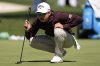 Min Woo Lee, of Australia, lines up a shot on the putting green during a practice round at the Masters golf tournament, Tuesday, April 8, 2025, in Augusta, Ga. (AP Photo/George Walker IV)