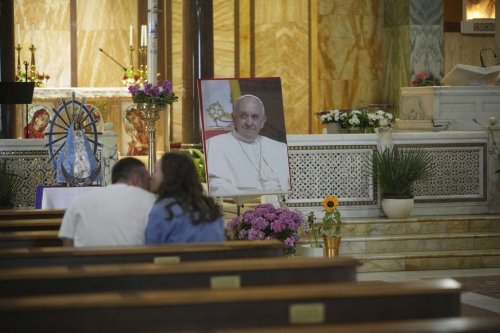 A picture of Pope Francis lies in front of the altar at the Argentinian Church in Rome, Monday, April 21, 2025. (AP Photo/Alessandra Tarantino)