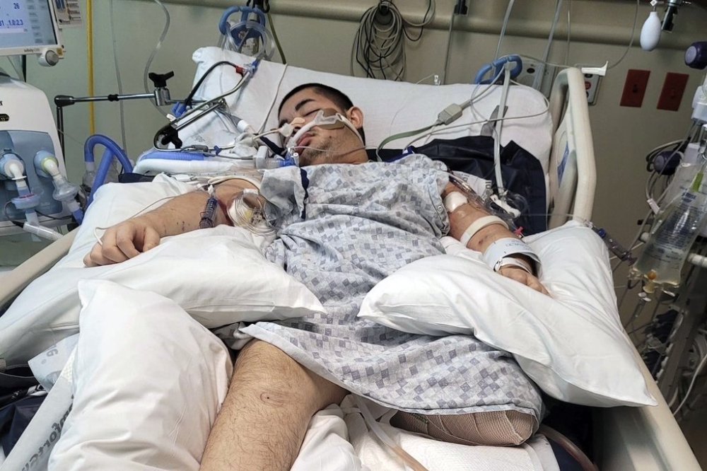 This photo provided by Ana L Vazquez, shows Victor Perez in a hospital bed in Pocatello, Idaho. (Ana L Vazquez via AP)