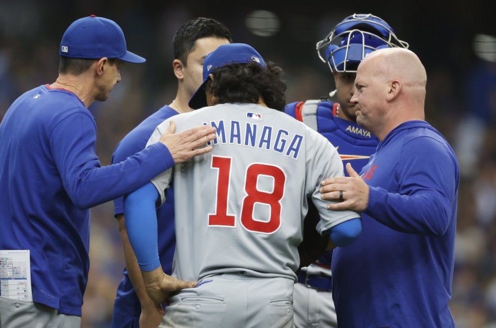 Chicago Cubs pitcher Shota Imanaga (18) is consoled after getting injured during the sixth inning of a baseball game against the Milwaukee Brewers, Sunday, May 4, 2025, in Milwaukee. (AP Photo/Jeffrey Phelps)