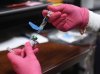 Anna Hicks prepares a measles, mumps and rubella vaccine at the Andrews County Health Department, Tuesday, April 8, 2025, in Andrews, Texas. (AP Photo/Annie Rice)