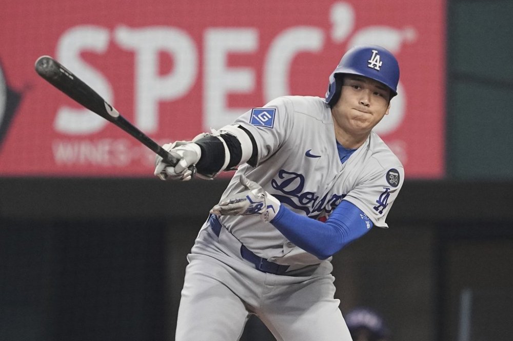 Los Angeles Dodgers' Shohei Ohtani follows through on a ground out in the first inning of a baseball game against the Texas Rangers in Arlington, Texas, Sunday, April 20, 2025. (AP Photo/Tony Gutierrez)