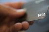 FILE - A Visa logo is displayed on a credit card in New Orleans, Aug. 11, 2019. (AP Photo/Jenny Kane, File)