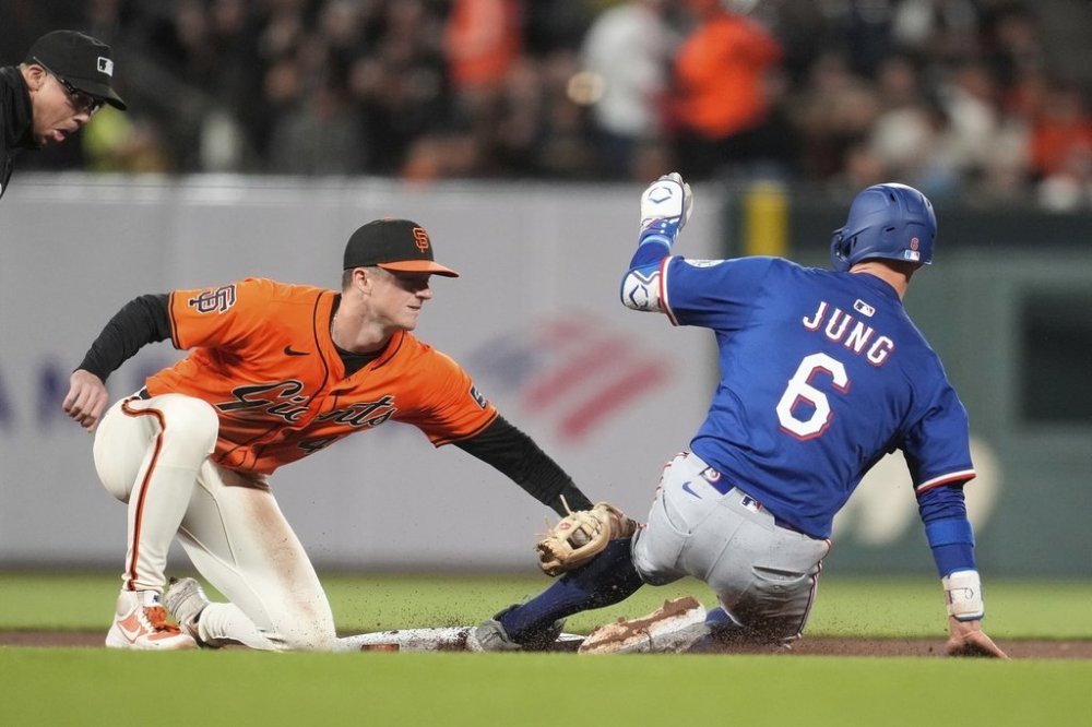 Texas Rangers' Josh Jung (6) is tagged out trying to steal second base by San Francisco Giants second baseman Tyler Fitzgerald during the seventh inning of a baseball game in San Francisco, Friday, April 25, 2025. (AP Photo/Jeff Chiu)