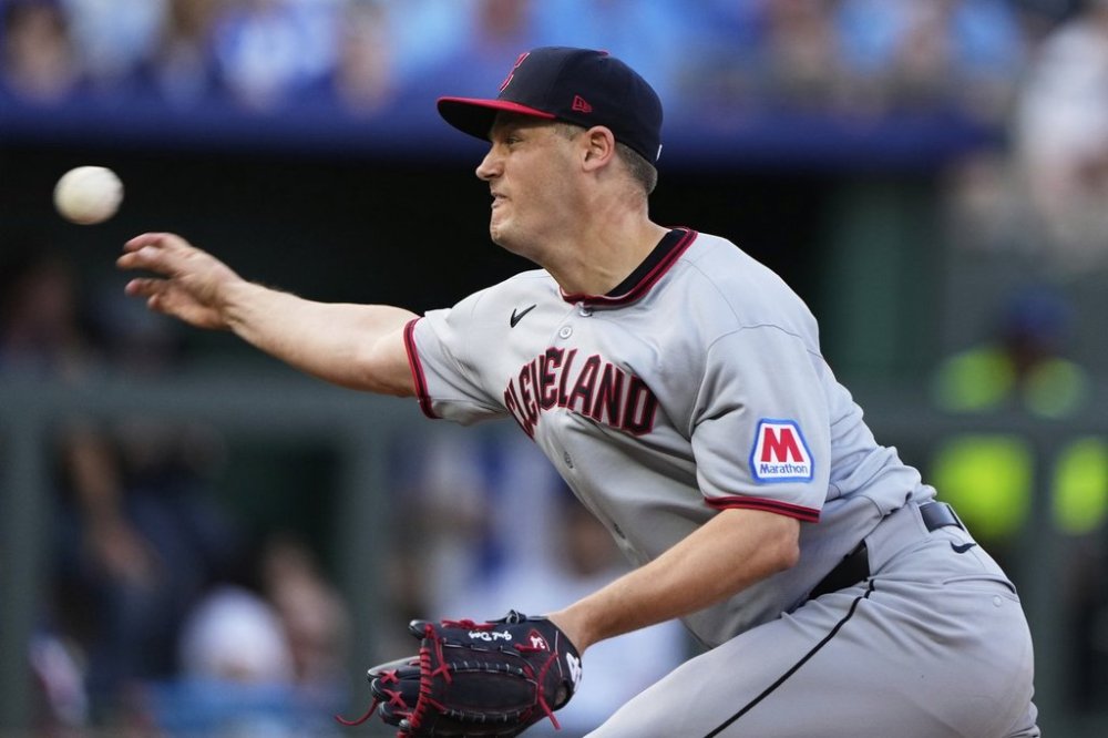 FILE - Cleveland Guardians relief pitcher Paul Sewald throws during the 10th inning of a baseball game against the Kansas City Royals, March 27, 2025, in Kansas City, Mo. (AP Photo/Charlie Riedel, File)