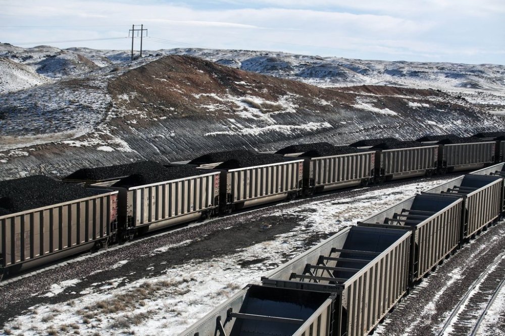 FILE - Rail cars are filled with coal and sprayed with a topper agent to suppress dust north of Douglas, Wyo,, Jan. 9, 2014. (Ryan Dorgan/Casper Star-Tribune via AP, File)