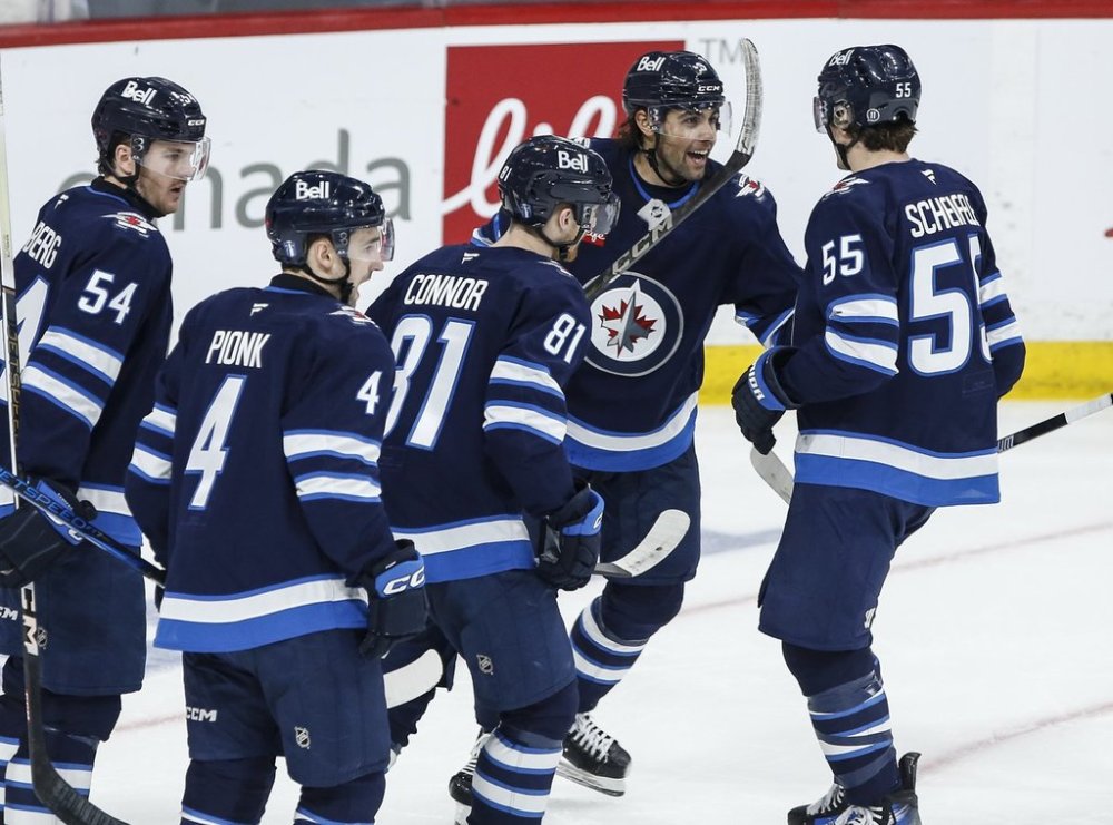 Winnipeg Jets' Dylan Samberg (54), Neal Pionk (4), Kyle Connor (81) Alex Iafallo (9) and Mark Scheifele (55) celebrate Iafallo's goal against the St. Louis Blues during third period NHL playoff action in Winnipeg on Saturday, April 19, 2025. THE CANADIAN PRESS/John Woods
