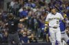Milwaukee Brewers' Christian Yelich (22) is called out on strikes during the first inning of a baseball game against the Chicago Cubs, Saturday, May 3, 2025, in Milwaukee. (AP Photo/Jeffrey Phelps)