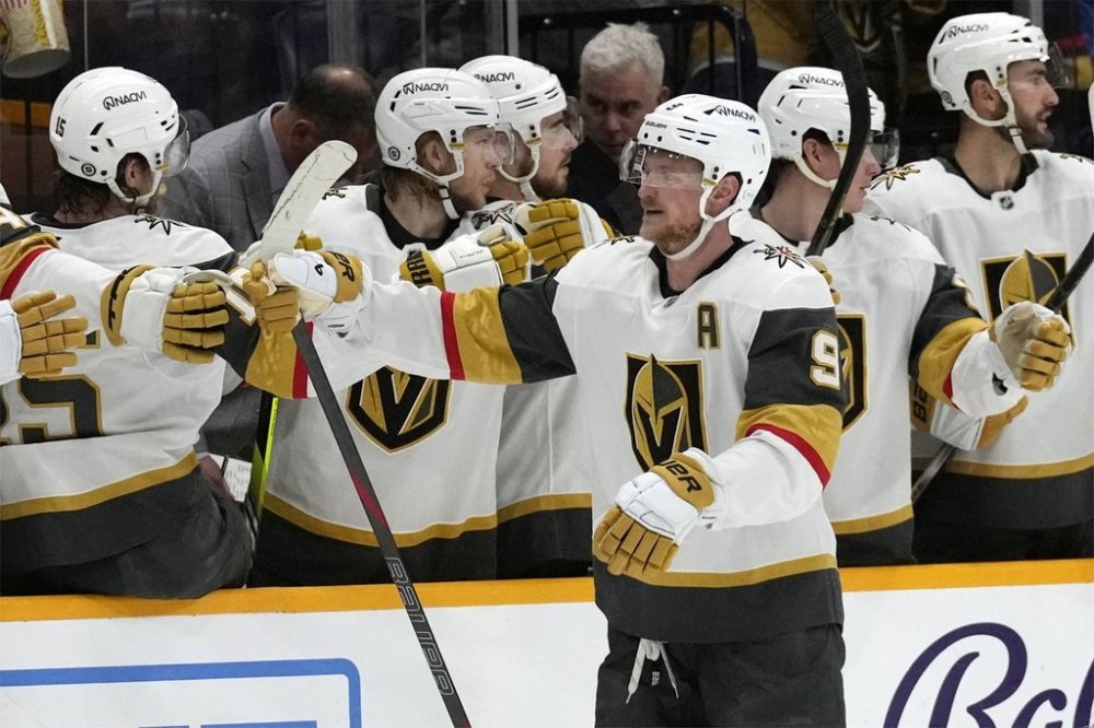 Vegas Golden Knights center Jack Eichel (9) is congratulated after scoring a goal against the Nashville Predators during the second period of an NHL hockey game Saturday, March 29, 2025, in Nashville, Tenn. (AP Photo/Mark Humphrey)