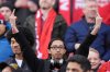 A Toronto FC fan gives the middle finger gestures during playing of the national anthem of the United States prior to first half MLS soccer action between Toronto FC and Chicago Fire, in Toronto, Saturday, March 15, 2025. THE CANADIAN PRESS/Frank Gunn