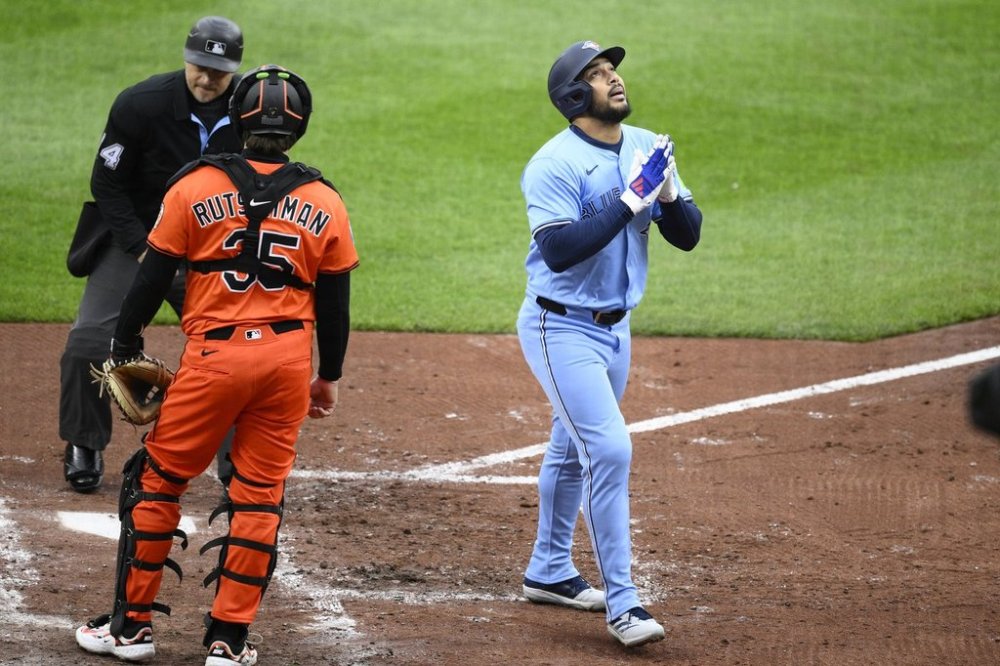 Toronto Blue Jays' Anthony Santander, right, celebrates his home run next to Baltimore Orioles catcher Adley Rutschman (35) during the third inning of a baseball game, Saturday, April 12, 2025, in Baltimore. (AP Photo/Nick Wass)