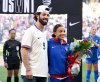 FILE - Chicago Cubs baseball player Dansby Swanson stands with his wife and United States Women's National Team soccer player, Mallory Swanson (9), who is being honored for her 100th game, before an international friendly women's soccer match against Iceland, Sunday, Oct. 27, 2024, in Nashville, Tenn. (AP Photo/John Amis, File)