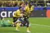 Dortmund's Serhou Guirassy, right, celebrates after scoring his side's third goal during the Champions League quarterfinals second leg soccer match between Borussia Dortmund and Barcelona, at the Signa-Iduna Park in Dortmund, Germany, Tuesday, April 15, 2025. (AP Photo/Martin Meissner)