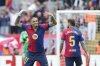 Barcelona's Raphinha, left, celebrates after scoring his side's third goal during a Spanish La Liga soccer match between Barcelona and Celta de Vigo at the Lluis Companys Olympic stadium in Barcelona, Spain, Saturday, April 19, 2025. (AP Photo/Joan Monfort)