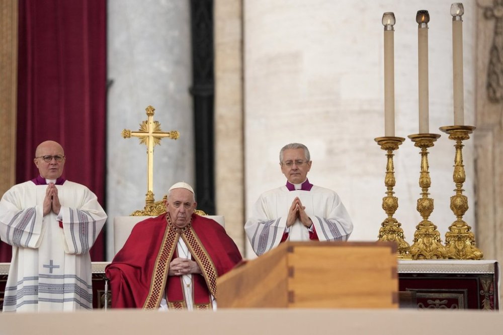 FILE - Pope Francis sits by the coffin of late Pope Emeritus Benedict XVI in St. Peter's Square during a funeral mass at the Vatican, on Jan. 5, 2023. (AP Photo/Andrew Medichini, File)