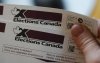An eligible voter holds a voter information card after it arrived in the mail in Carleton Place, Ont., Friday, April 11, 2025. THE CANADIAN PRESS/Sean Kilpatrick
