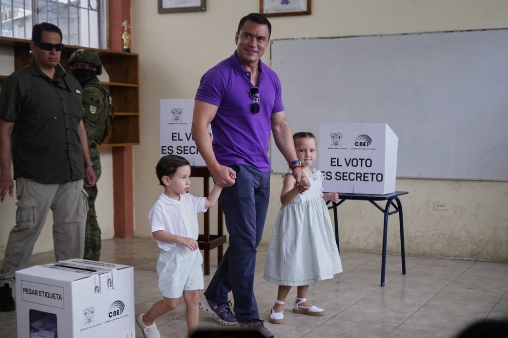 Incumbent President Daniel Noboa holds his children's hands after voting in the presidential election runoff in Olon, Ecuador, Sunday, April 13, 2025. (AP Photo)