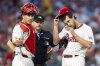 Philadelphia Phillies starting pitcher Aaron Nola, right, waits for a new PitchCom as catcher J.T. Realmuto, left, looks on during the fifth inning of a baseball game against the Arizona Diamondbacks, Saturday, May 3, 2025, in Philadelphia. (AP Photo/Chris Szagola)