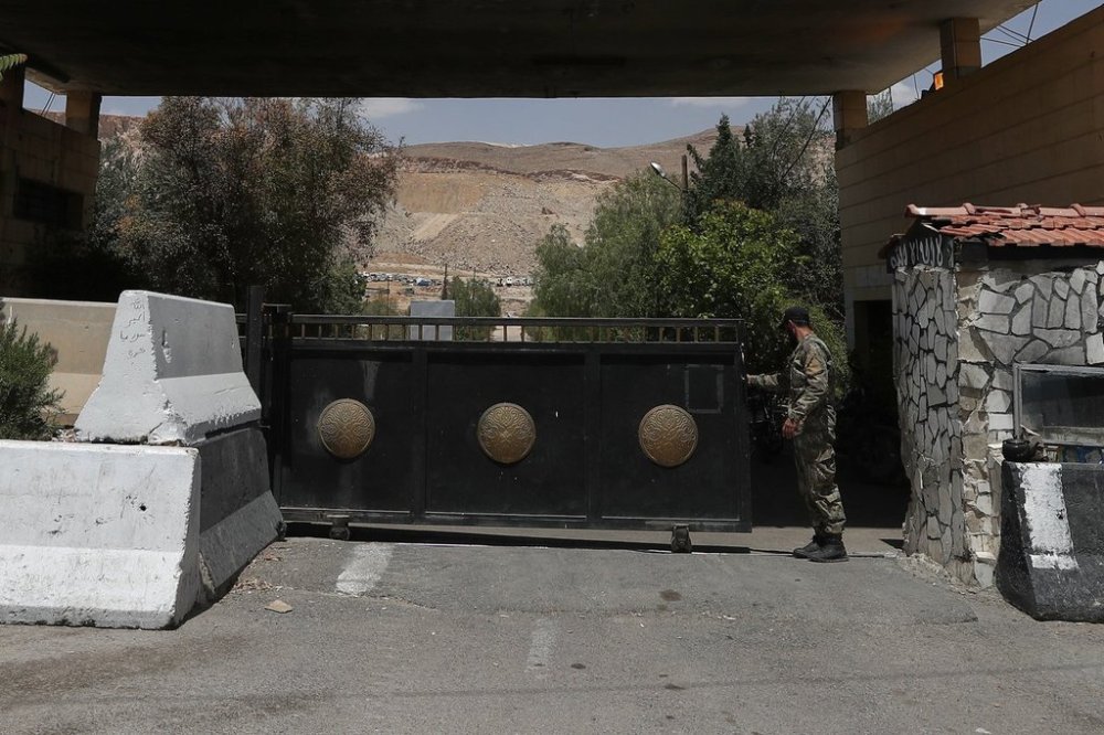 A Syrian soldier closes the gate of a military base on the outskirts of Harasta, near Damascus, Syria, Saturday, May 3, 2025. (AP Photo/Omar Sanadiki)