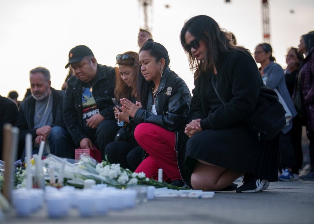 People pray during a vigil for the victims of an attack that killed 11 people at a Vancouver Lapu Lapu festival, in Ottawa, on Monday, April 28, 2025. A person drove a car into a crowd of people at the festival in Vancouver on Saturday April 26, 2025. THE CANADIAN PRESS/Chris Tanouye