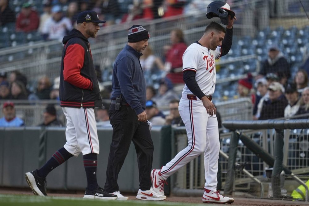 Minnesota Twins' Matt Wallner (38), right, leaves the game with manager Rocco Baldelli and a trainer after sustaining an injury during the first inning of a baseball game against the New York Mets, Tuesday, April 15, 2025, in Minneapolis. (AP Photo/Abbie Parr)