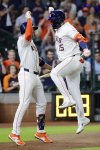 Houston Astros' Jeremy Pena, left, and Isaac Paredes (15) celebrate the solo home run by Paredes against the Toronto Blue Jays during the seventh inning of a baseball game Tuesday, April 22, 2025, in Houston. (AP Photo/Michael Wyke)