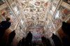 FILE - Visitors admire the Sistine Chapel inside the Vatican Museums on the occasion of the museum's reopening, in Rome, May 3, 2021. (AP Photo/Alessandra Tarantino, file)