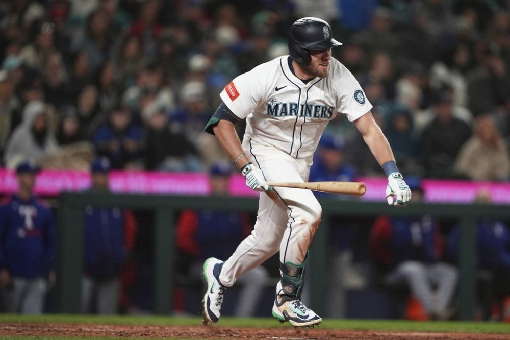 Seattle Mariners' Luke Raley follows through on a two-run single to score J.P. Crawford and Julio Rodriguez during the seventh inning of a baseball game against the Texas Rangers, Saturday, April 12, 2025, in Seattle. (AP Photo/Lindsey Wasson)