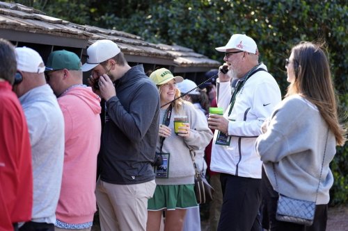 Patrons line up to use courtesy phones during a practice around at the Masters golf tournament, Wednesday, April 9, 2025, in Augusta, Ga. (AP Photo/Ashley Landis)