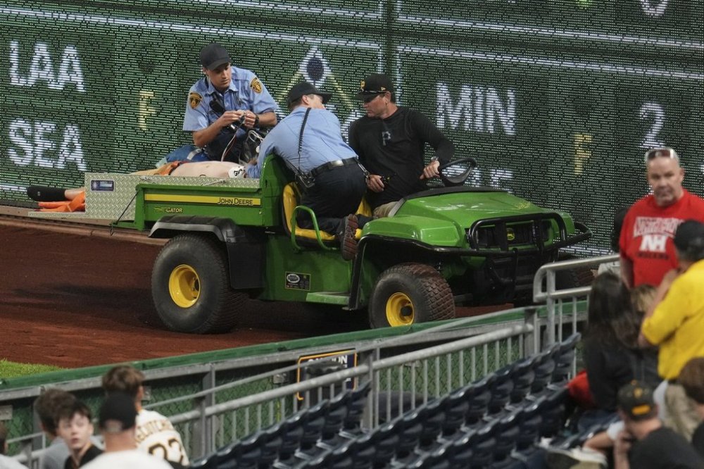 A fan is carted off the field at PNC Park after falling out of the stands during the seventh inning of a baseball game between the Pittsburgh Pirates and the Chicago Cubs in Pittsburgh, Wednesday, April 30, 2025. (AP Photo/Gene J. Puskar)