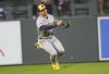 Milwaukee Brewers left fielder Isaac Collins pulls in a shallow fly ball off the bat of Colorado Rockies' Ryan McMahon to end the fifth inning of a baseball game Tuesday, April 8, 2025, in Denver. (AP Photo/David Zalubowski)